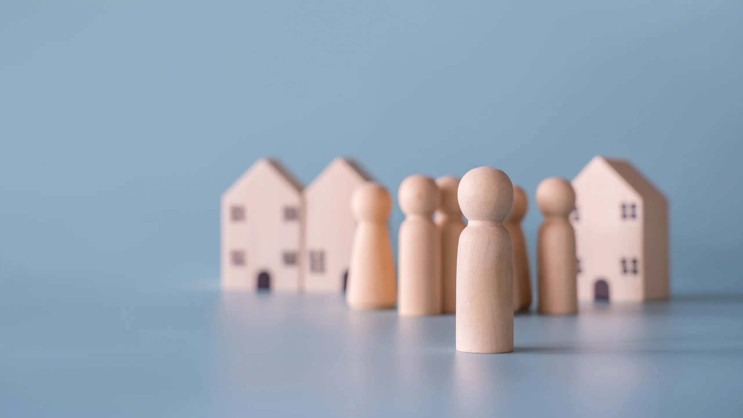 Small wooden figures of a human family, symbolizing the sensitive nature of housing and legal processes.